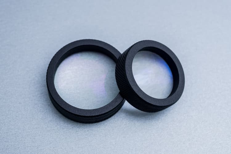 two black silicone washers on gray background