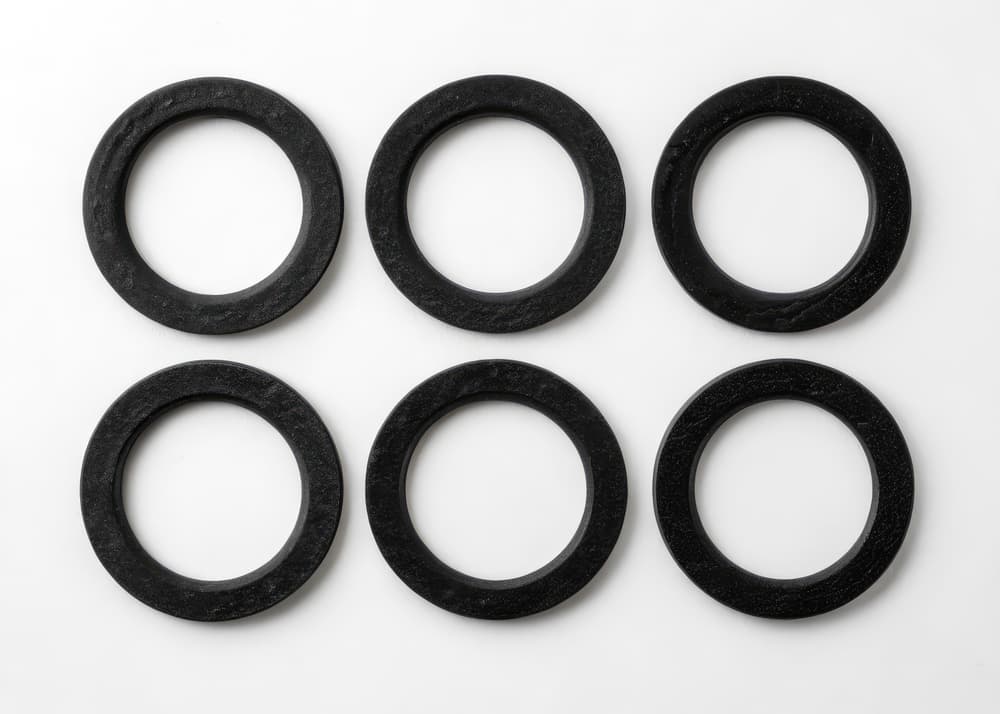 six black rubber gaskets on white background