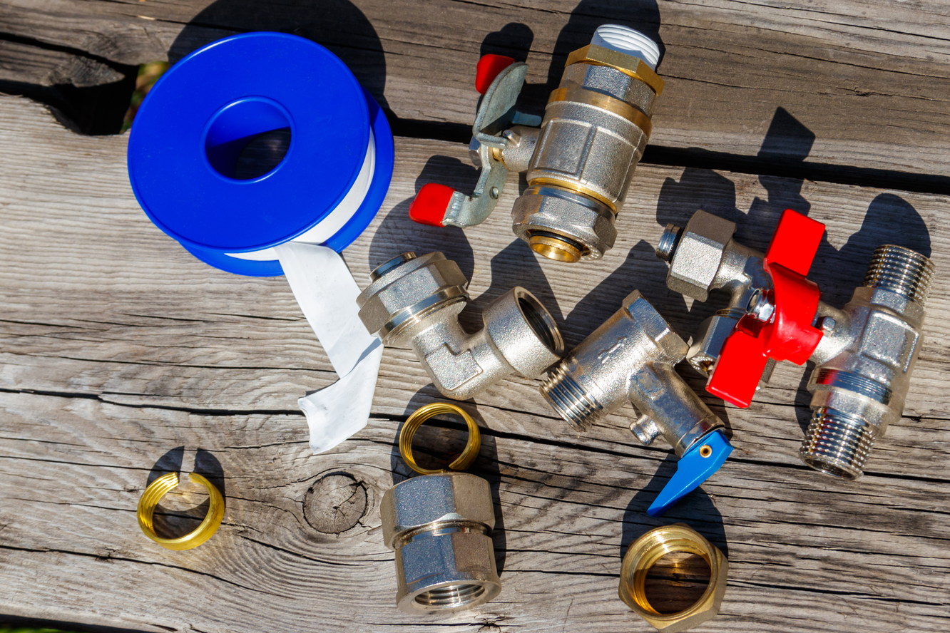 plumbing fittings and tools on wood